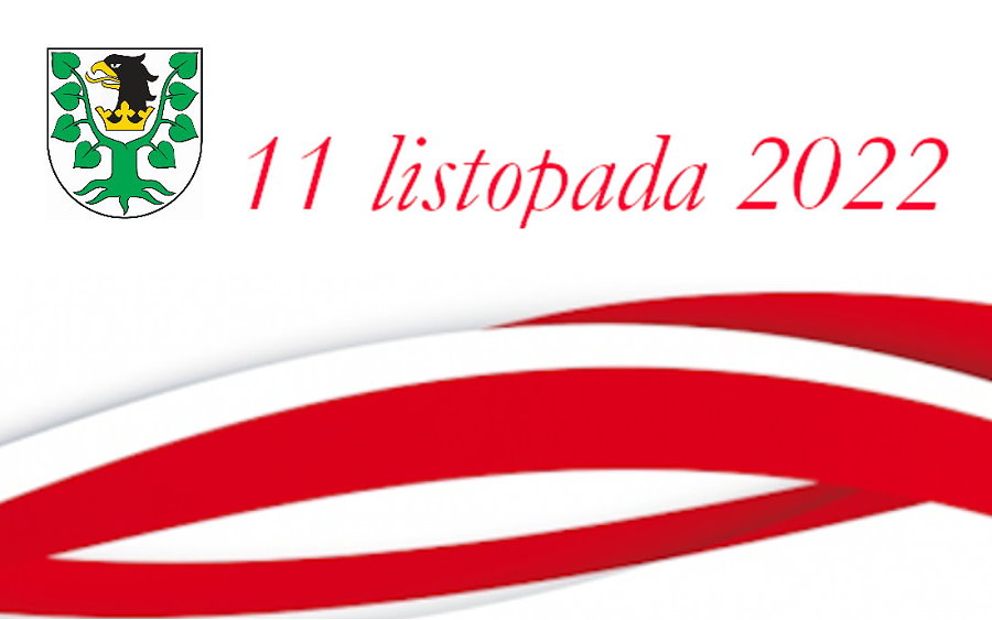Grafika. Na górze herb Powiatu Oleckiego. Przedstawia on głowę orła z dziobem i koroną na szyi pomiędzy 2 konarami lipy, z których każdy ma 4 liście. Obok napis: 11 listopada 2022. Pod nim barwy Polski.