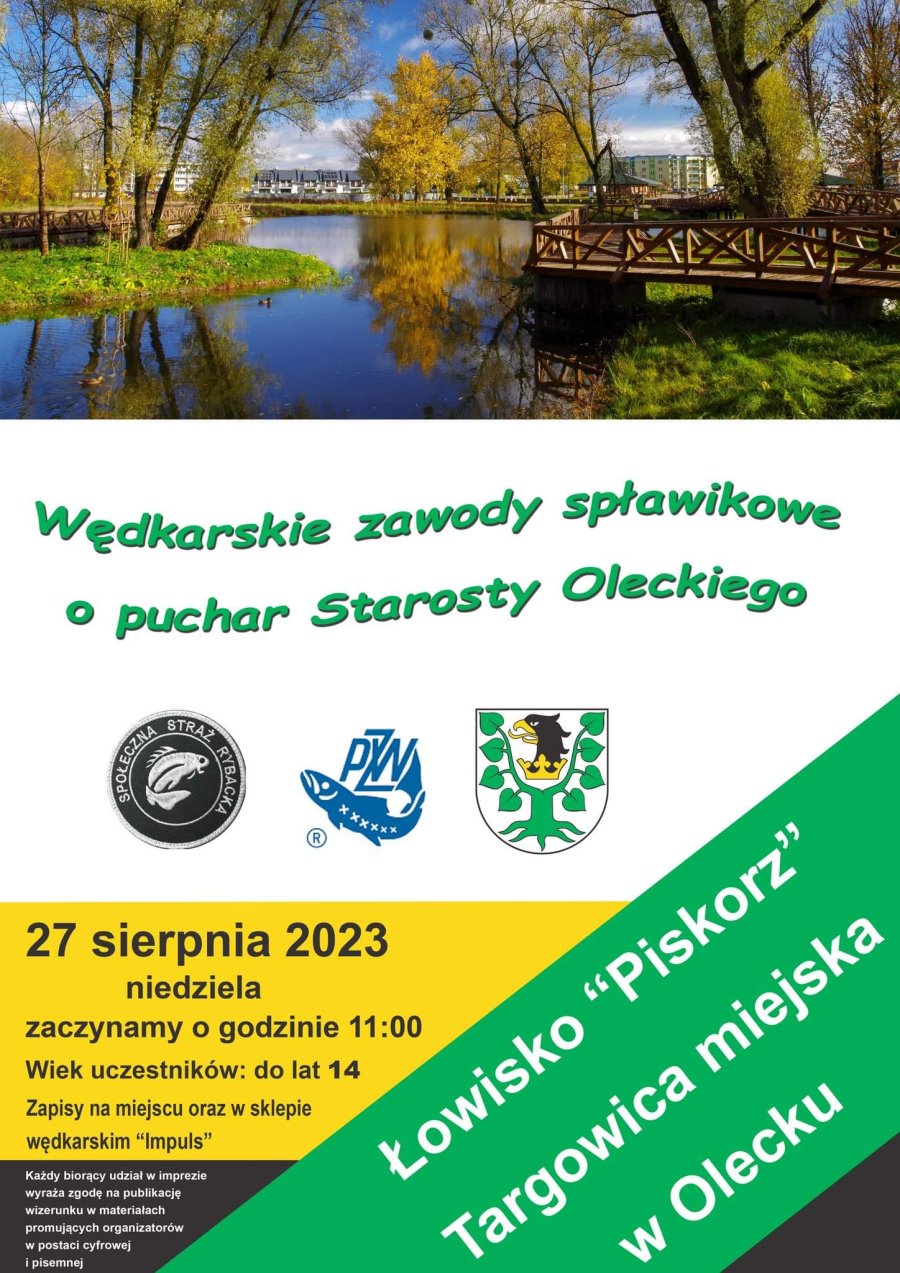 Widok na zbiornik wodny otoczony drzewami. Wędkarskie zawody spławikowe o puchar Starosty Oleckiego